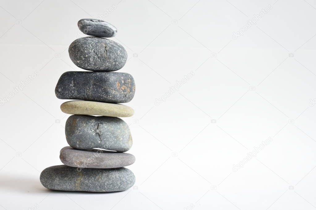 Stack stones isolated in white background. Pebbles tower. Concept of balance and harmony. Calm and spirit, spa stones and zen, peace, meditation, spiritual, abstract