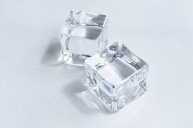 Gri renkli, beyaz arkaplan, kristal kaplı şeffaf buz küpleri