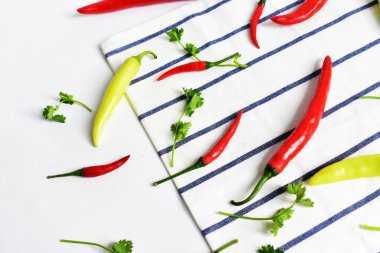 Kırmızı biber, yeşil kırmızı biber dilimleri / beyaz arka planda yarı izole edilmiş, deri döşeme, üst manzara, beyaz masada Tayland biberi.