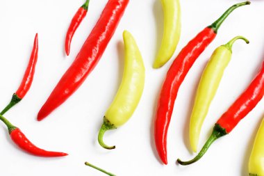 Kırmızı biber, yeşil kırmızı biber dilimleri / beyaz arka planda yarı izole edilmiş, deri döşeme, üst manzara, beyaz masada Tayland biberi.