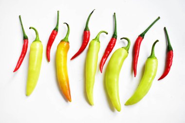 Kırmızı biber, yeşil kırmızı biber dilimleri / beyaz arka planda yarı izole edilmiş, deri döşeme, üst manzara, beyaz masada Tayland biberi.