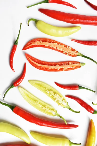 Red chili, green yellow chili peppers slices/cut/half isolated in white background, flay lay, top view, Thai chili in white table