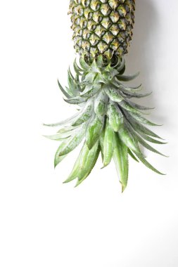 Yeşil ananas ve portakal ananasları, parlak sarı arka planda izole edilmiş taze tropikal meyve arka planında, yaz / bayram, yiyecek ve içecek, sulu, serin, vegan, sağlıklı gıda, fitness