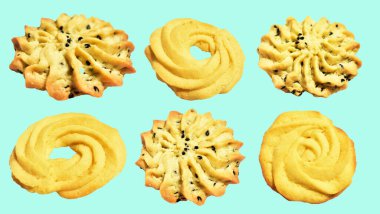 Rosette şekilli ev yapımı tereyağlı kurabiyeler kırpma yolu ile izole edilmiş yeşil arka planda gölge yok