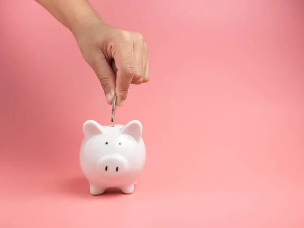 Hucha Blanca Sobre Fondo Rosa Mano Humana Poniendo Moneda Hucha — Foto de Stock