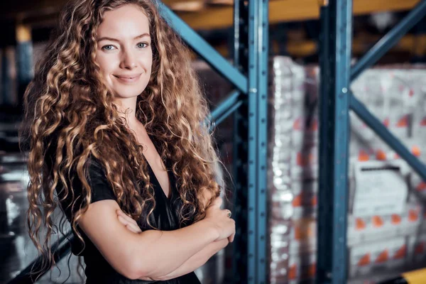 Confident Caucasian woman owner standing and crossed her arm at goods warehouse store and check for control loading containers box from Cargo freight ship for import and export