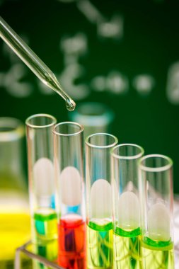 Kimyasal laboratuvar arka planında test tüplerine sıvı atmak, bilim laboratuvarı araştırma ve geliştirme konsepti