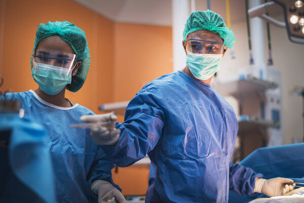 Team of doctors or surgeons in hospital surgery operating emergency room showing patient heart rate, during coronavirus or covid-19 crisis, medical concept.medical concept. 