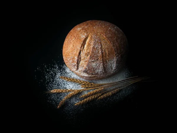 Siyah zemin üzerinde taze pişmiş ekmek.