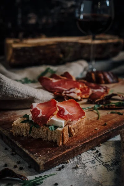 Sliced smoked meat on wooden cutting board