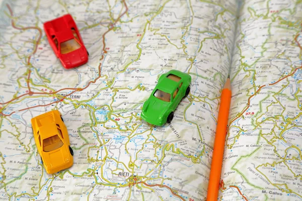 Toy cars on a road map