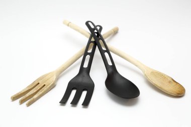 Mutfak kepçeleri beyaz arka planda farklı malzemelerle