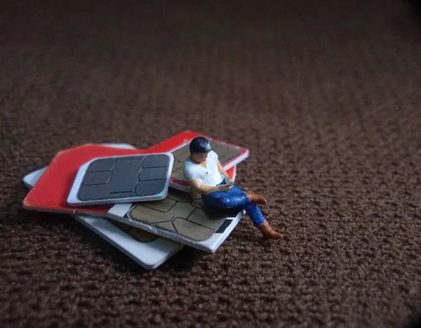 Oturan Adam SIM Kart 'ta akıllı telefon tutuyor, İletişim Teknolojisi İlgili Görüntü