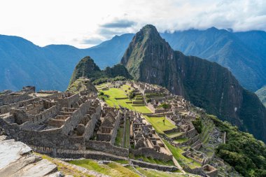 Machu Picchu, Peru 'daki ikonik İnka kalesi, detaylı taş kalıntıları, yeşil terasları ve Huayna Picchu dağıyla. Bir UNESCO Dünya Mirası sahası ve Dünya 'nın Yedi Harikası' ndan biri..