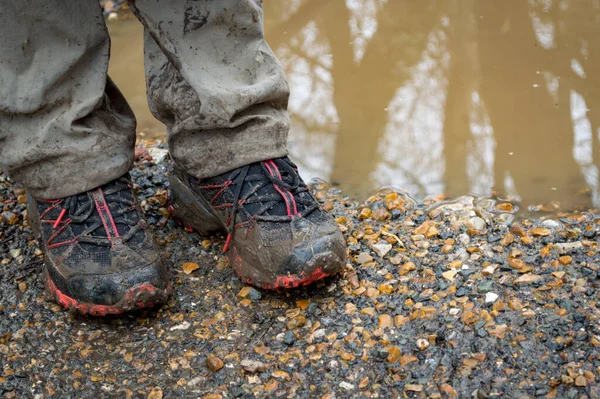 Muddy hiking shoes, isolated outdoors. Female, Isle of Wight UK