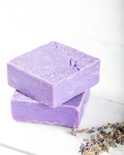 Lavender soap with dried lavender on wooden background.
