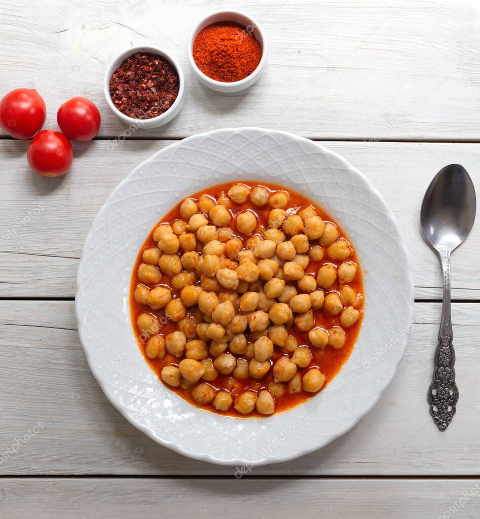 Vegetarian tasty spicy chick pea soup on a wooden background / Cheakpea stew/  Turkish nohut pilaki