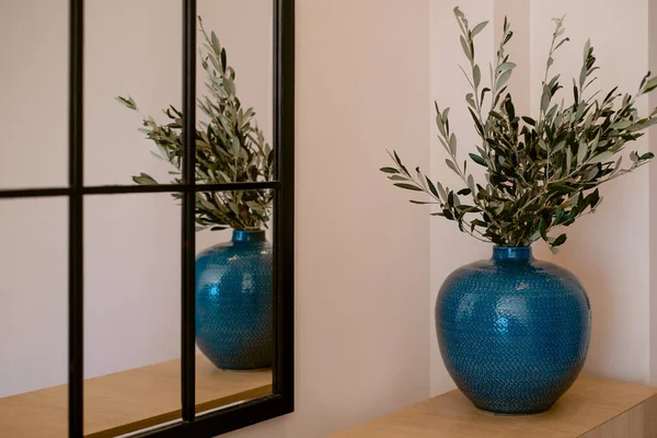 stock image Blue vase stands near the mirror in the interior