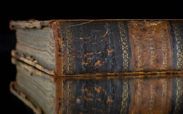 Spine of an Old (19th century) book on a mirror with Manual of the biblical history written by H. van Heijningen