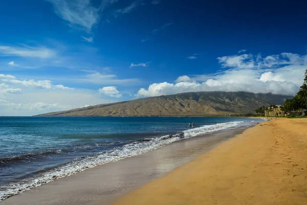 Gentle waves on beautiful sandy Kihei Beach in Maui, Hawaiian Islands.