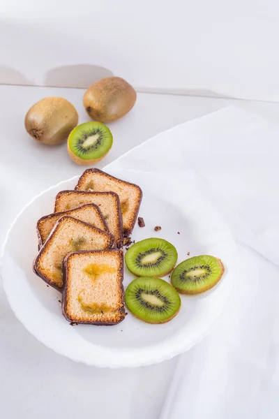 Beautiful photography kiwi plum cake, ripe kiwi , white plate, white background