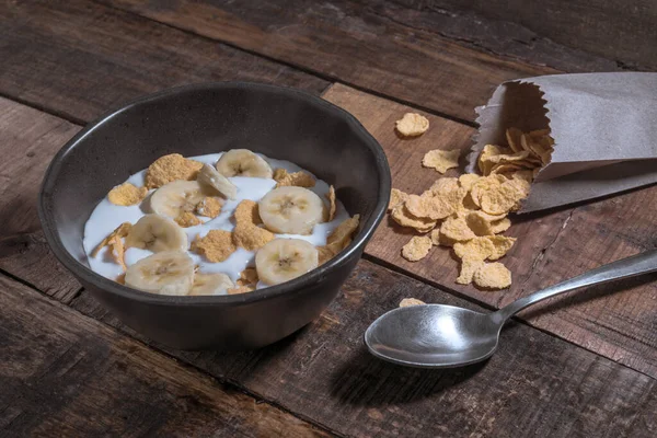 corn flakes with milk and banana chunks for breakfast