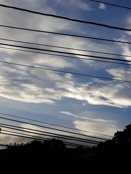 Sunrise in Guatemala City, clouds, cables and architecture in Latin America.