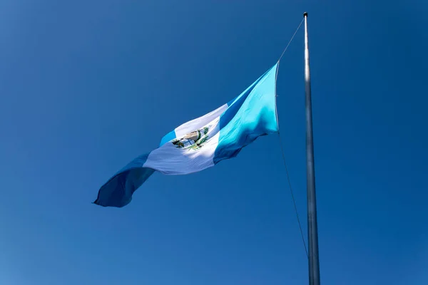 National flag of Guatemala, Central America, to the wind in antler, patriotic symbol, September 12, 1968 current version. Guatemala flag, national symbol, waving on the wind