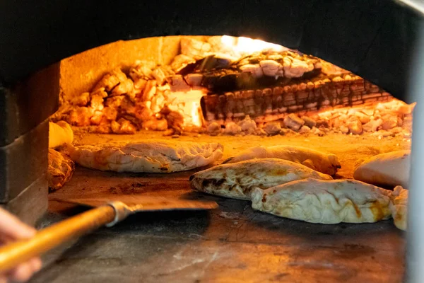 Traditional oven with wood fire. Furnace with fire intense fire, calzone, Italian food.