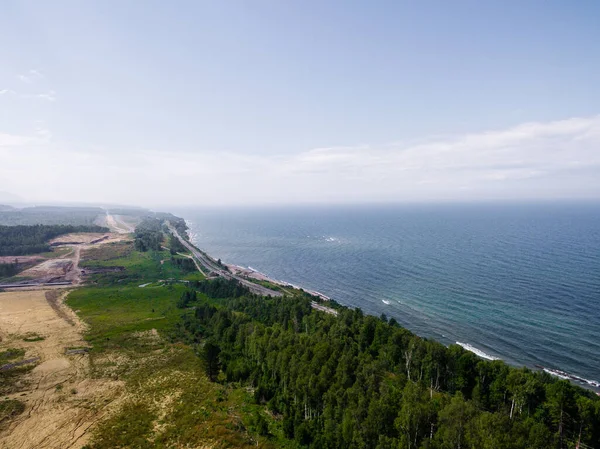 Trans-Siberian Railway on the Baikal lake shore from aerial view. The largest freshwater lake
