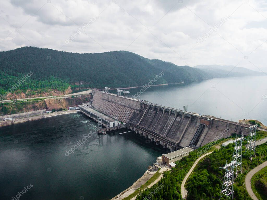 Krasnoyarsk hydroelectric station dam, hydro power plant on Enisey river from aerial view. Krasnoyarsk reservoir. Industrial landscape