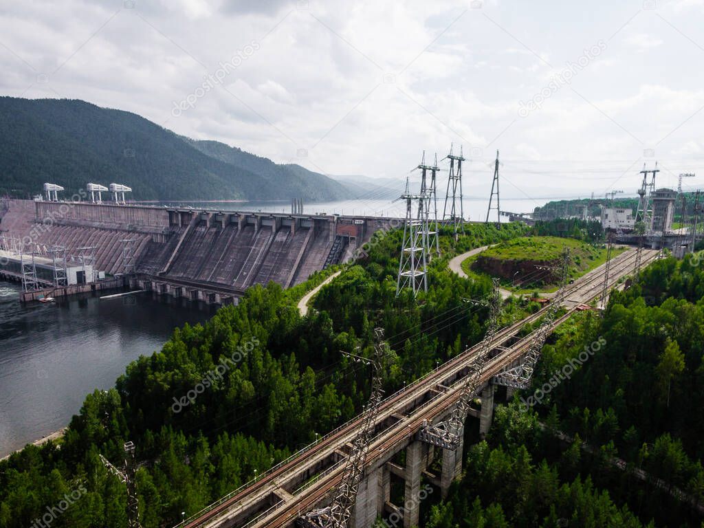 Krasnoyarsk hydroelectric station dam, hydro power plant on Enisey river from aerial view. Krasnoyarsk reservoir. Industrial landscape