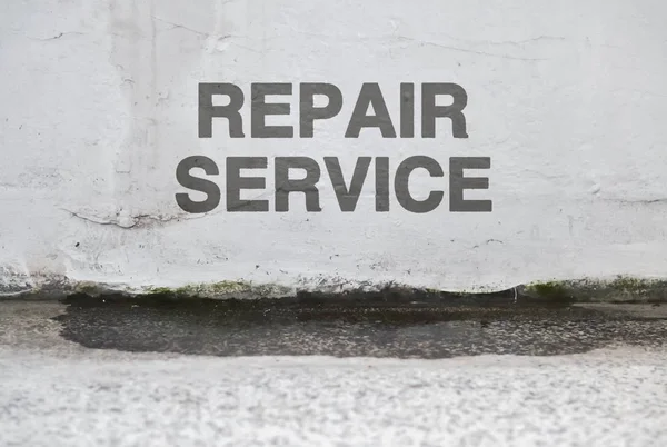 Text Repair Service over a damaged wet wall that needs renovation