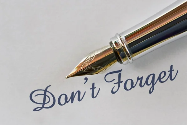 Text Don\'t Forget and a fountain pen on bright background