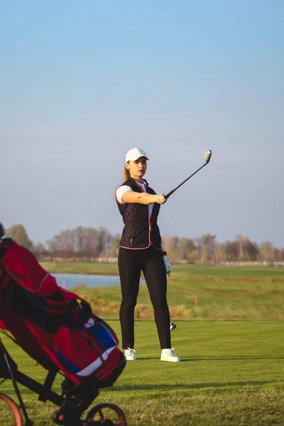 Jovem bela mulher está treinando golfe no outono — Fotografia de Stock