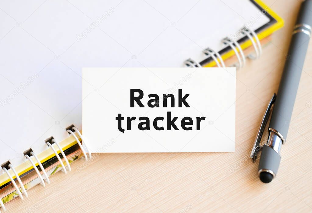 Rank tracker - text on a notebook with a spring and a gray pen