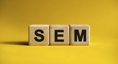 Tahta küplerin sarı arkaplanındaki SEM metni