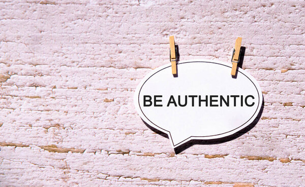 Be Authentic on a white sheet with wooden pins