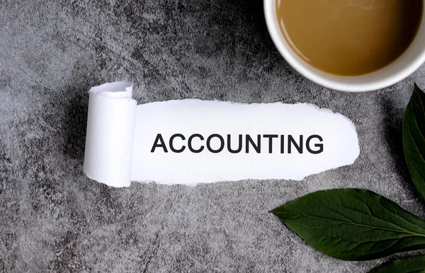 Accounting with cup of coffee and green leaf