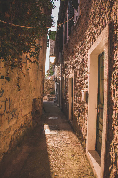 View of a narrow sunny street in the city, Herceg Novi, Montenegro