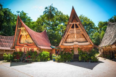Traditional sumatran wooden house with original roof clipart