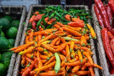 Süpermarkette kırmızı ve yeşil biberli sepet. 