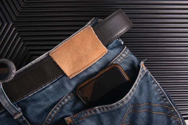 smart phone in back pocket blue jean