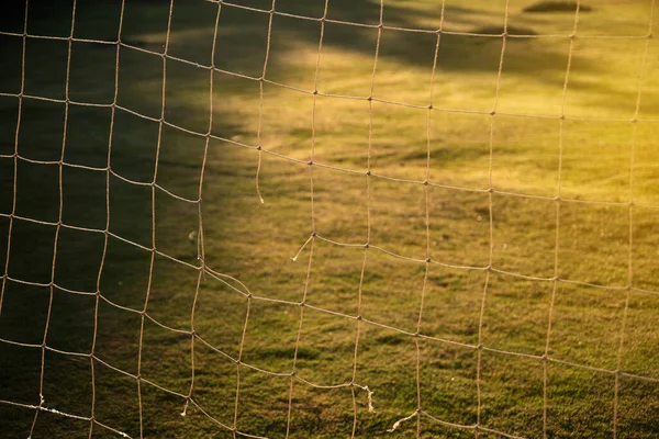 close up of soccer goal net in the morning sun