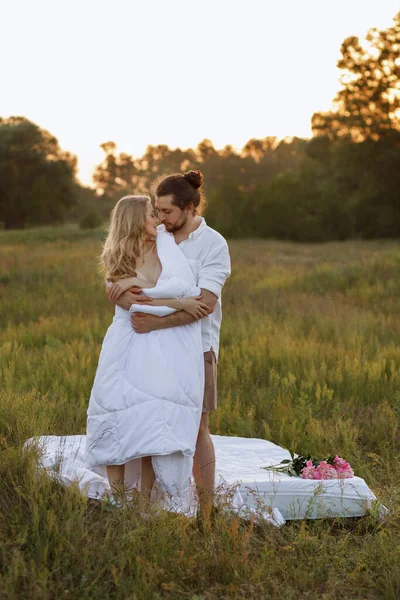 A couple in bed at sunset is happy