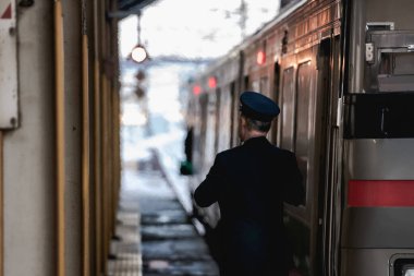 Demiryolu mühendisi, platforma güvenli ya da değil giren yolcuları kontrol ediyor..
