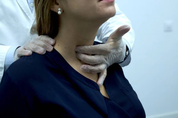 endocrine physician performing a physical exam on the neck of a patient with endocrine system problems. Thyroid, Hyperthyroidism