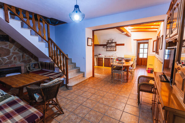 Living room and kitchen inside an old style rural rental house.