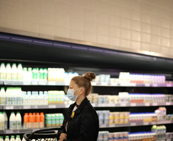 supermarket shopping, face mask and gloves,Woman choosing a dairy products at supermarket