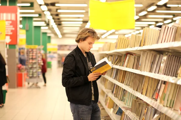 Man buying a book in a store